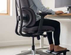 Person sitting in ergonomic office chair with correct posture alignment and lumbar support